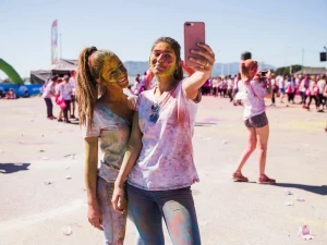 Portrait of a smiling young women taking selfie on mobile phone