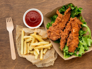 High angle fried chicken and fries with ketchup.